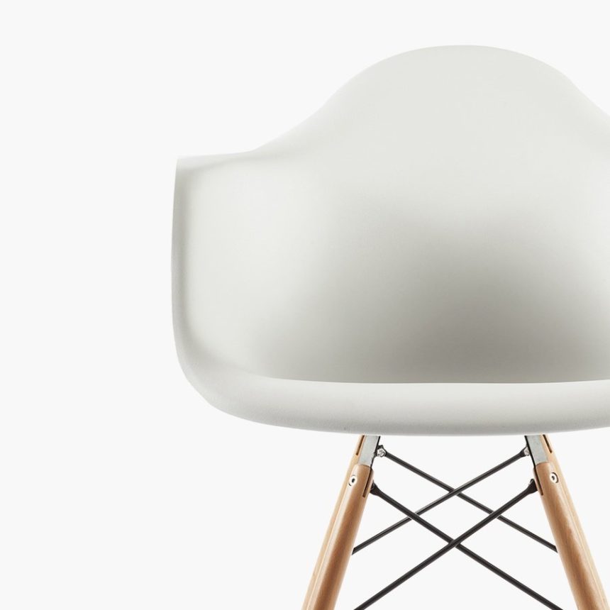 Modern white chair with wooden legs.