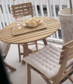 Outdoor patio set with bread and glasses.