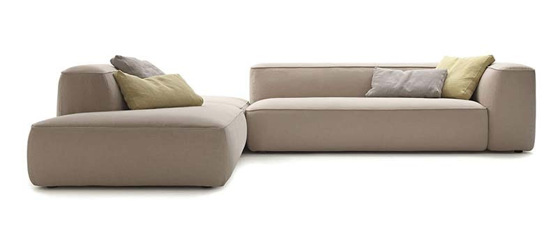Modern beige sectional sofa with cushions.