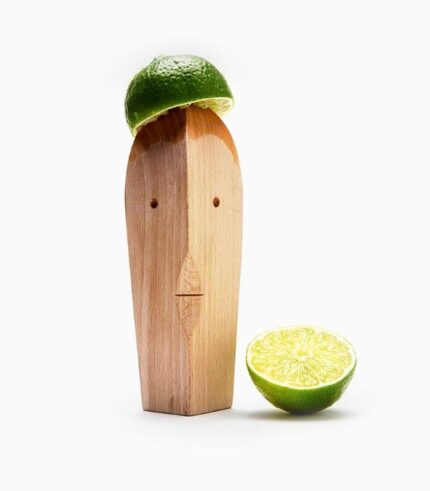Wooden sculpture with lime hat and slice.