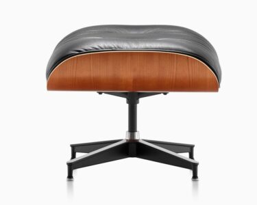 Black leather ottoman with wooden base.