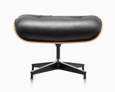 Black leather ottoman with wooden accents.