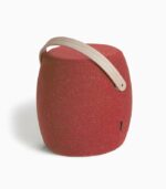Red portable stool with wooden handle.