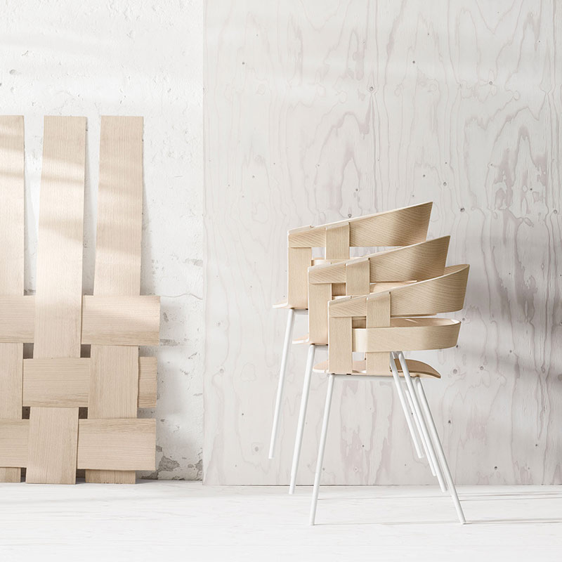Woven wooden chairs in minimalist setting.