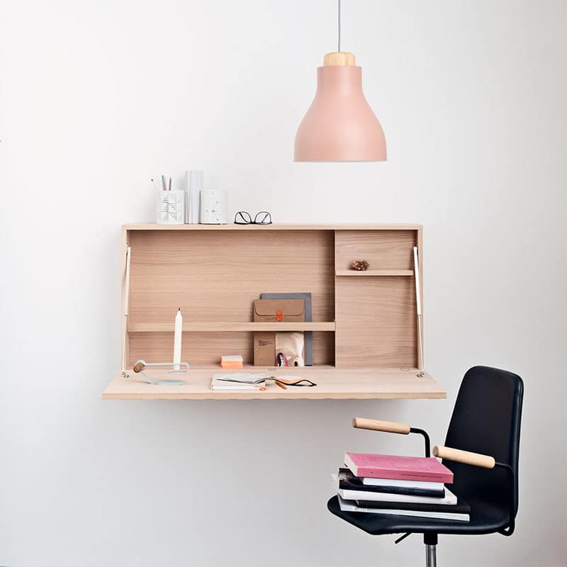 Minimalist desk with chair and hanging lamp.