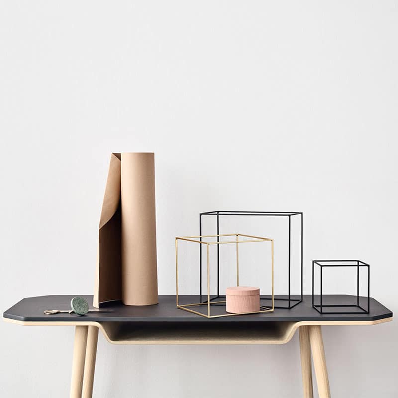 Minimalist table with geometric decor objects.