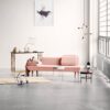 Minimalist room with pink sofa and decor.