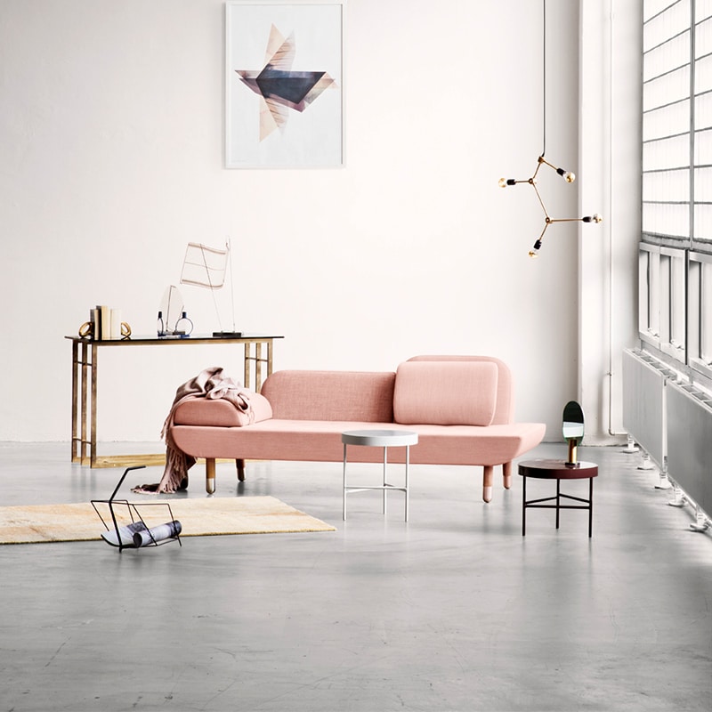 Minimalist room with pink sofa and decor.