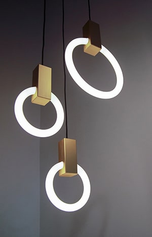 Modern circular pendant lights, dark background.