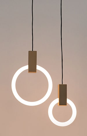 Two modern circular pendant lights hanging.