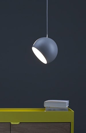 Hanging lamp above cabinet with books.