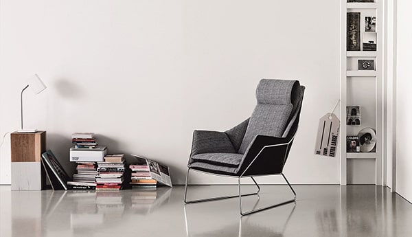 Modern chair in minimalist reading corner.