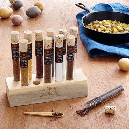 Spice tubes and skillet on wooden table.