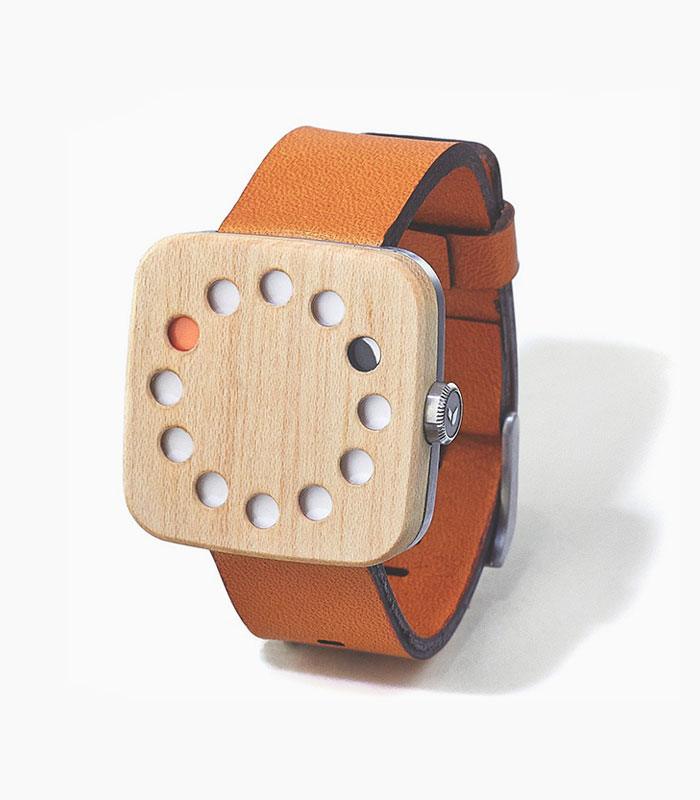 Wooden watch with orange leather strap.