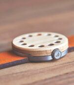 Wooden watch with orange leather strap.