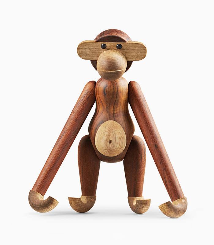 Wooden monkey figurine with long limbs.