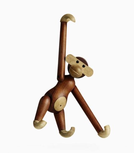 Wooden monkey toy hanging by one arm.
