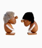 Wooden figures with fur hats facing each other.