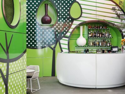 Modern bar with vibrant green decor.