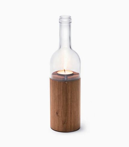 Wine bottle candle holder with lit candle.