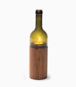 Wine bottle candle holder with wooden base.