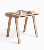 Wooden desk with books and pencils.